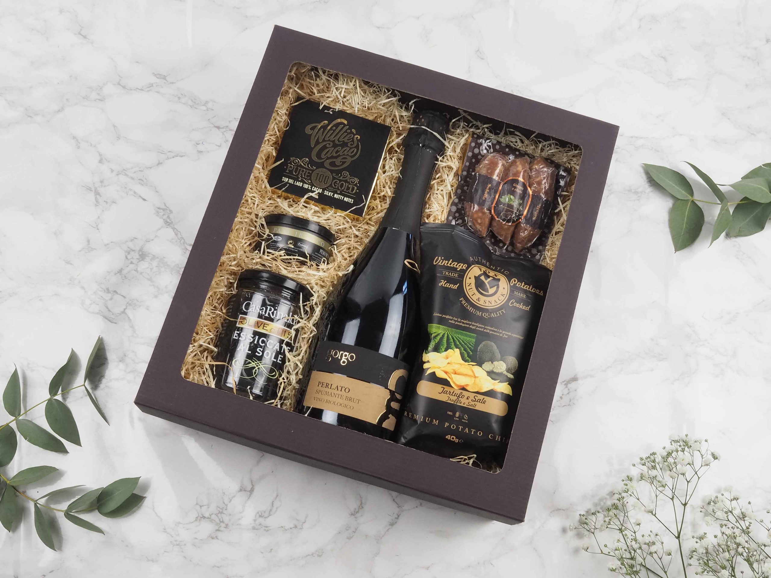 Dárková krabička v sobě ukrývá italské perlivé víno, 100% hořkou čokoládu Willies, paté Ibérico, černé sušené olivy, salsiccia z divočáka s kořením a chipsy s lanýžovou příchutí. Všechny pochutiny jsou baleny v elegantní a ekologické papírové krabičce. Obdarujte s chutí malým degustačním zážitkem.