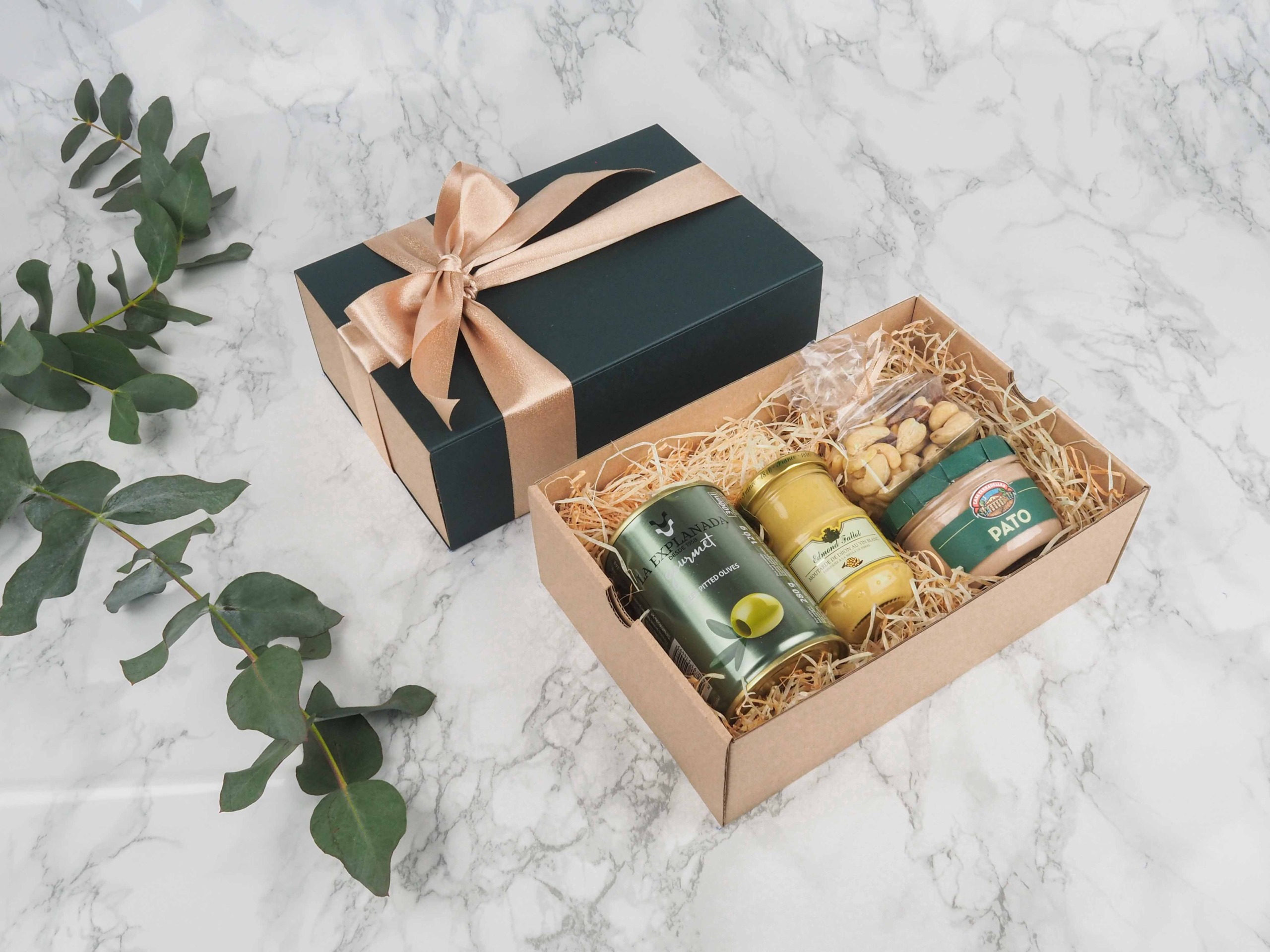 Dárkový balíček Casa Green je speciální svou elegantní vysouvací krabičkou, kterou zdobí atlasová stuha. Dárková krabice v sobě obsahuje zelené olivy bez pecek, dijon francouzskou hořčici, mix oříšků a španělskou vepřovou játrovou paštiku s bylinkami.